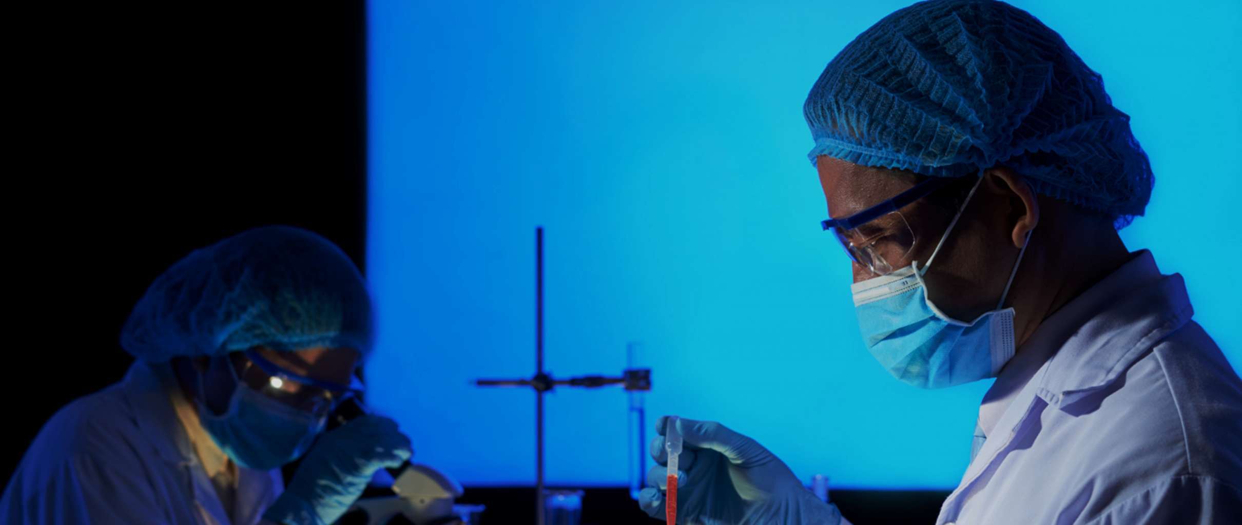 Two scientists investigating a sample in a lab